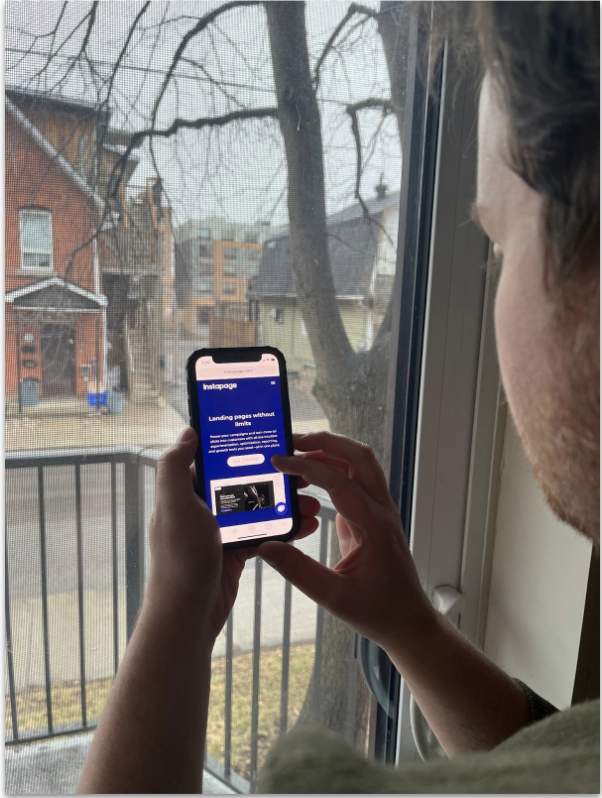 Person testing a landing page creator on mobile