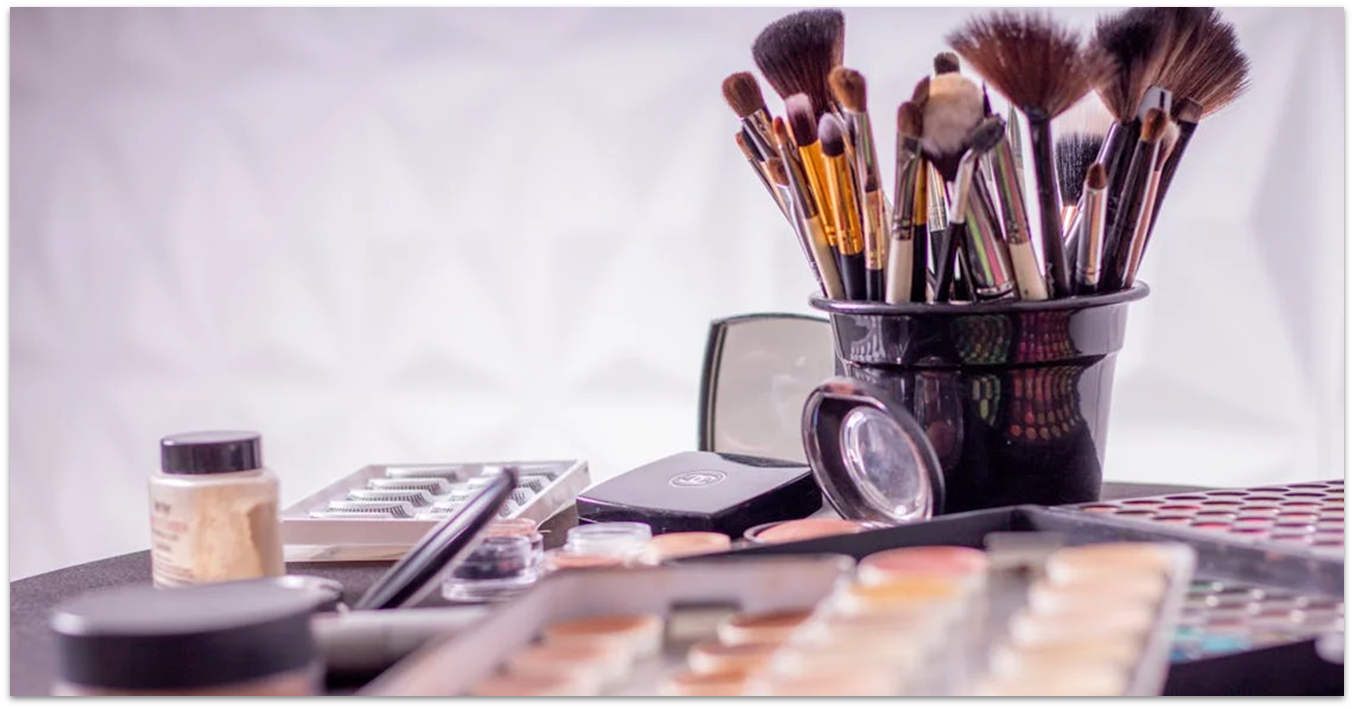 Makeup brushes and eyeshadows on a table
