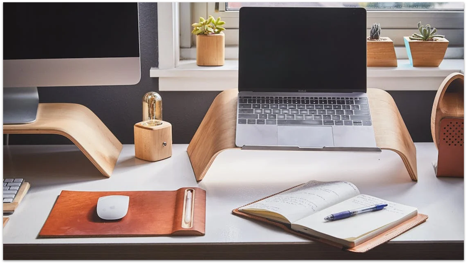 Computers and home office supplies on top of a desk