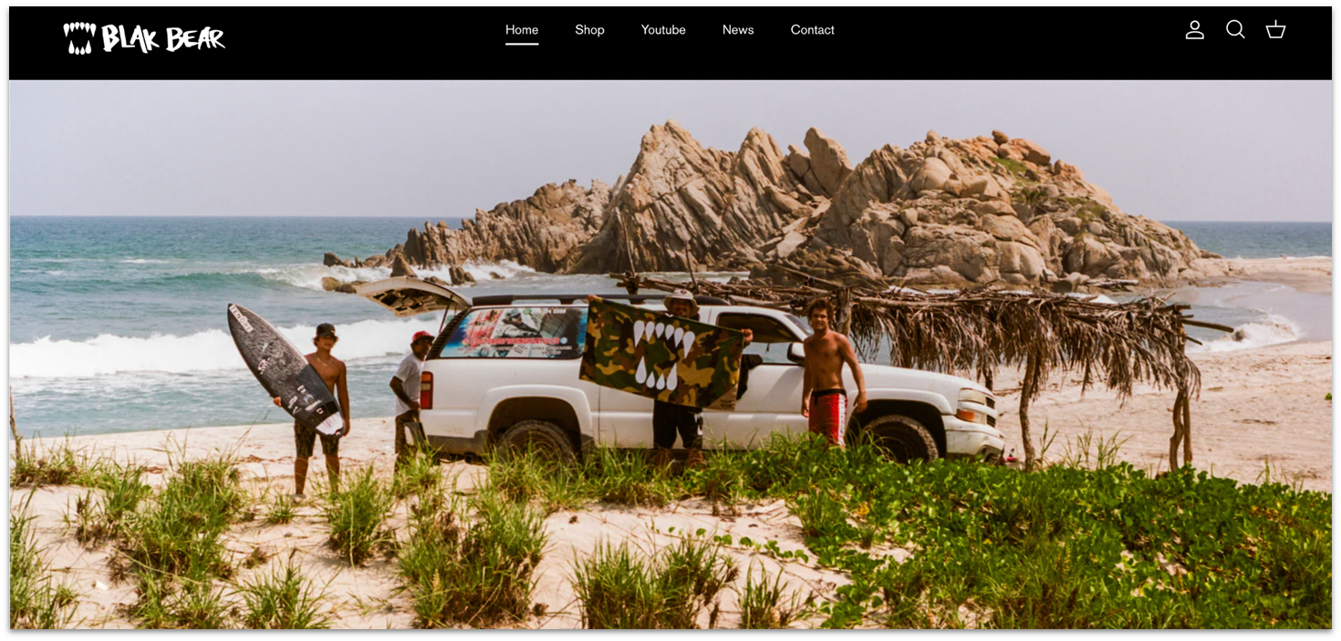 Blak Bear Shopify store idea, showing surfers standing near a car on a beach.