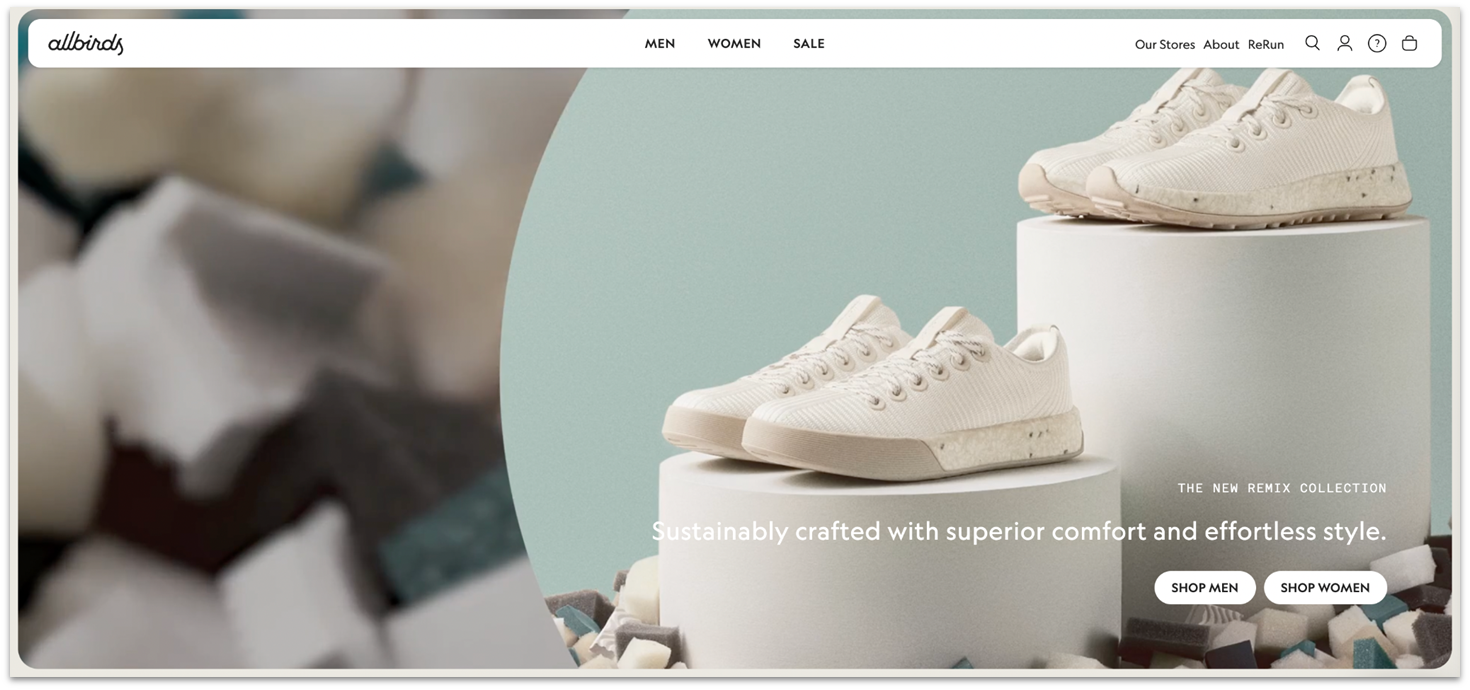 Allbirds' homepage showing two white sneakers on stands of varying heights.